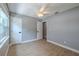 Bedroom showcasing gray walls, doors, light-colored floors, and natural light from a bright window at 4044 Red Fox Ct, Wesley Chapel, FL 33543