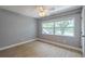 Neutral bedroom with a ceiling fan and a bright window offering ample natural light at 4044 Red Fox Ct, Wesley Chapel, FL 33543
