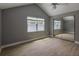 Bedroom featuring vaulted ceilings, mirrored closet, and natural light from a bright window at 4044 Red Fox Ct, Wesley Chapel, FL 33543
