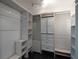 Walk-in closet with adjustable shelving and drawers for ample storage space at 4044 Red Fox Ct, Wesley Chapel, FL 33543