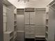 Large walk-in closet features custom shelving, drawers and ample storage for shoes and accessories at 4044 Red Fox Ct, Wesley Chapel, FL 33543