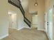 Bright and airy entryway with modern chandelier, wood floors and dark staircase at 4044 Red Fox Ct, Wesley Chapel, FL 33543