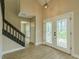 Bright entryway features a modern light fixture, wood floors, and decorative glass doors leading to the outside at 4044 Red Fox Ct, Wesley Chapel, FL 33543