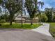 Charming home features a palm tree, long driveway, and large grassy area at 4044 Red Fox Ct, Wesley Chapel, FL 33543