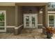 Front door features decorative glass, neutral colors, and covered entry at 4044 Red Fox Ct, Wesley Chapel, FL 33543