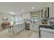 Bright kitchen featuring white cabinets, an island with a breakfast bar, and stainless steel appliances at 4044 Red Fox Ct, Wesley Chapel, FL 33543