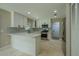 Modern kitchen featuring white cabinets, stainless steel appliances, and peninsula with counter seating at 4044 Red Fox Ct, Wesley Chapel, FL 33543