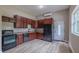 Bright kitchen featuring wooden cabinets, black appliances and durable countertops perfect for cooking at 4044 Red Fox Ct, Wesley Chapel, FL 33543