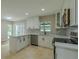 Bright kitchen featuring white cabinets, an island with a breakfast bar, and stainless steel appliances at 4044 Red Fox Ct, Wesley Chapel, FL 33543