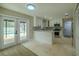 Modern kitchen featuring white cabinets, stainless steel appliances, and bar seating at the kitchen island at 4044 Red Fox Ct, Wesley Chapel, FL 33543