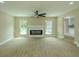 Open-concept living room featuring a fireplace, ceiling fan, and wood floors at 4044 Red Fox Ct, Wesley Chapel, FL 33543