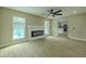 Open-concept living room features a fireplace, ceiling fan, and wood floors at 4044 Red Fox Ct, Wesley Chapel, FL 33543