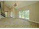 Bright living room with wood floors, large windows, and modern lighting fixture at 4044 Red Fox Ct, Wesley Chapel, FL 33543