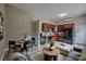 A modern living room with beautiful flooring, stylish furniture, and sleek, dark kitchen appliances at 4044 Red Fox Ct, Wesley Chapel, FL 33543