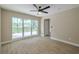 Bright living room featuring large window showcasing the landscaped yard and laminate flooring at 4044 Red Fox Ct, Wesley Chapel, FL 33543