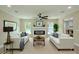 Staged living room featuring fireplace, ceiling fan, and access to the dining area at 4044 Red Fox Ct, Wesley Chapel, FL 33543