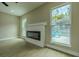 Cozy living room with fireplace and views of screened in pool area at 4044 Red Fox Ct, Wesley Chapel, FL 33543