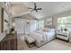 Relaxing main bedroom with vaulted ceilings, closets, and bedside tables at 4044 Red Fox Ct, Wesley Chapel, FL 33543