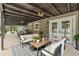 Relaxing outdoor living area featuring stylish seating, a view of the screened pool and a dining space at 4044 Red Fox Ct, Wesley Chapel, FL 33543