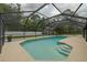 A screened-in pool with tanning ledge, set in a private backyard, offering a luxurious outdoor experience at 4044 Red Fox Ct, Wesley Chapel, FL 33543