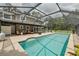 Beautiful screened-in pool with patio, outdoor seating, and lush landscaping create a serene backyard oasis at 4044 Red Fox Ct, Wesley Chapel, FL 33543