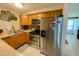 Well-equipped kitchen with stainless steel appliances and wood cabinets at 4214 Trucious Pl # 4212, New Port Richey, FL 34652