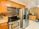 Functional kitchen featuring stainless steel appliances and ample cabinet space at 4214 Trucious Pl # 4212, New Port Richey, FL 34652