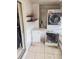 This laundry room features side-by-side freezer and washer and dryer at 4214 Trucious Pl # 4212, New Port Richey, FL 34652