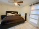 Cozy bedroom with a king-size bed and a sliding barn door at 4214 Trucious Pl # 4212, New Port Richey, FL 34652