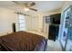 Bedroom featuring a king-size bed, barn door, and television at 4214 Trucious Pl # 4212, New Port Richey, FL 34652