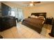 Bright main bedroom featuring a king-size bed and a television at 4214 Trucious Pl # 4212, New Port Richey, FL 34652