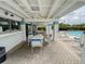 Charming covered pool area featuring tables, chairs, and ceiling fans for comfortable outdoor relaxation at 4214 Trucious Pl # 4212, New Port Richey, FL 34652
