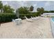 Relax poolside on comfortable lounge chairs with convenient umbrella-shaded tables for outdoor enjoyment at 4214 Trucious Pl # 4212, New Port Richey, FL 34652