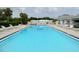 Enjoy a refreshing swim in this inviting outdoor swimming pool with ample seating and lounge chairs at 4214 Trucious Pl # 4212, New Port Richey, FL 34652