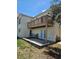 Back patio with balcony, chairs and small table at 4304 Harbor House Dr, Tampa, FL 33615