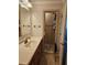 Bathroom featuring single sink vanity and tiled walk-in shower with glass door at 4304 Harbor House Dr, Tampa, FL 33615