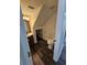 Cozy bathroom featuring a vanity, toilet, and unique storage space under the stairs, complemented by dark wood-look flooring at 4304 Harbor House Dr, Tampa, FL 33615