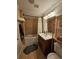 Compact bathroom featuring a bathtub, tiled walls, and a vanity with a large mirror, offering a functional and clean design at 4304 Harbor House Dr, Tampa, FL 33615