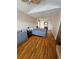 Bright bedroom boasts hardwood floors, a double bed, and plenty of natural light at 4304 Harbor House Dr, Tampa, FL 33615