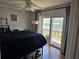 Bedroom with fan, sliding glass doors, and waterfront view beyond at 4304 Harbor House Dr, Tampa, FL 33615