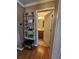 Hallway featuring hardwood floors, decor shelving, and a doorway leading to a bathroom at 4304 Harbor House Dr, Tampa, FL 33615