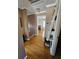 Hallway featuring hardwood floors and bonus ladder-style shelving for decor and storage at 4304 Harbor House Dr, Tampa, FL 33615