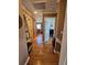 Hallway featuring hardwood floors, decor shelving, and access to bedrooms and other rooms at 4304 Harbor House Dr, Tampa, FL 33615