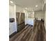 Open kitchen design with stainless appliances, stylish cabinets, a center island, and wood-look floors at 4304 Harbor House Dr, Tampa, FL 33615