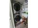 Efficient laundry closet with stacked washer/dryer and shelving, maximizing space for storage and convenience at 4304 Harbor House Dr, Tampa, FL 33615
