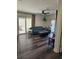 Open living room with ceiling fan, modern flooring, and access to the outdoor patio at 4304 Harbor House Dr, Tampa, FL 33615