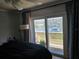 Bright bedroom boasts sliding glass doors opening to a private balcony with water views at 4304 Harbor House Dr, Tampa, FL 33615