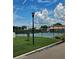Well-maintained tennis courts with a lovely landscape and beautiful light post at 4304 Harbor House Dr, Tampa, FL 33615