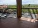 Balcony view overlooking lush green trees and a well-maintained parking lot at 4305 Bayside Village Dr # 301, Tampa, FL 33615