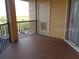 Balcony with black metal railings and tile flooring with a door at 4305 Bayside Village Dr # 301, Tampa, FL 33615
